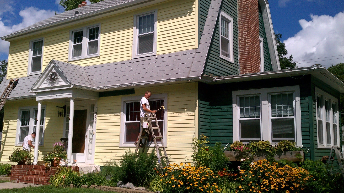 1st Class Painting crew painting a home exterior in Fargo, ND